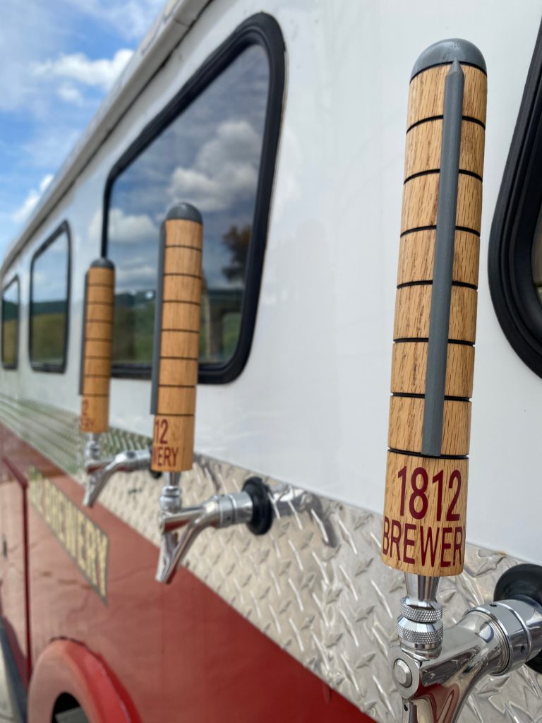Beer taps on the side of the firetruck.