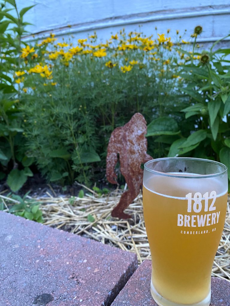 Big foot walking down the path towards a beer.