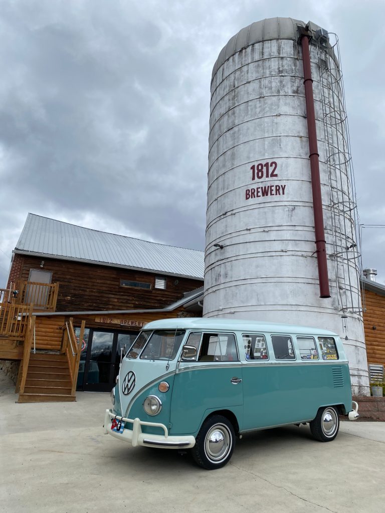 A Volkswagen bus in front of the silo.